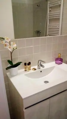 a bathroom with a white sink and a mirror at Oporto City View - Wonderful Apartment in Porto