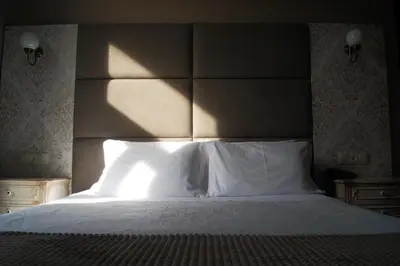 a bedroom with a large bed with white pillows at Hotel Chique Aliados in Porto