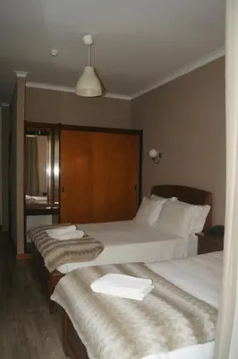 a hotel room with two beds with towels on them at Hotel Chique Aliados in Porto