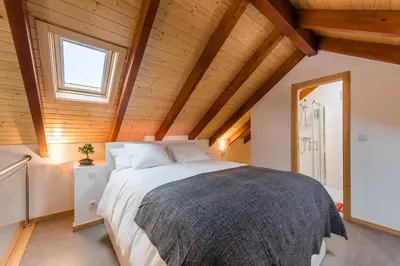 a bedroom with a large bed in a room with wooden ceilings at SOBRI Cork House - Sustainable Loft in Porto