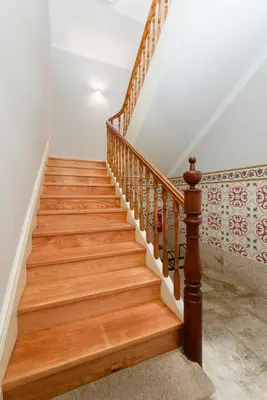 a wooden staircase with wooden railings in a house at Skylight Apartment in Porto