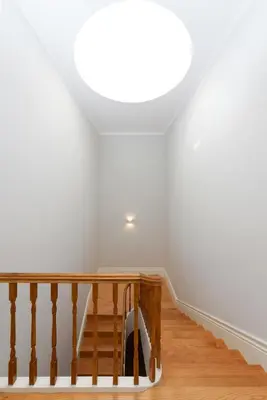 a room with a staircase with a light shining on the ceiling at Skylight Apartment in Porto