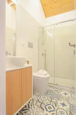 a bathroom with a sink and a toilet and a shower at Skylight Apartment in Porto