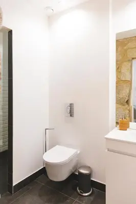 a white bathroom with a toilet and a sink at Aposentus - Your fabulous home next to Ribeira in Porto