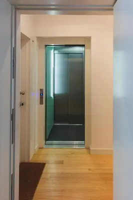 a hallway with a glass door in a building at Aposentus - Your fabulous home next to Ribeira in Porto