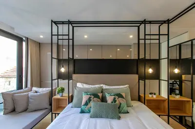 a bedroom with a large bed with some pillows at Chillout Trindade Apartment in Porto