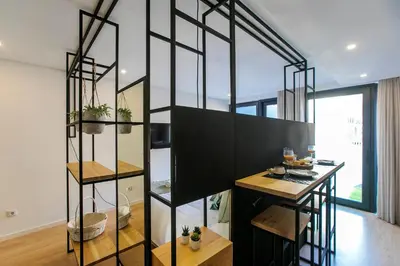 a room with a spiral staircase in a house at Chillout Trindade Apartment in Porto