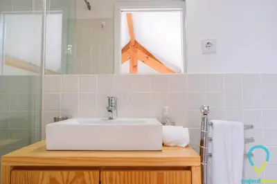 a bathroom with a white sink and a mirror at Loft Almada in Porto