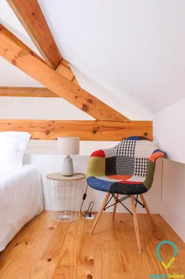 a bedroom with a chair and a bed at Loft Almada in Porto