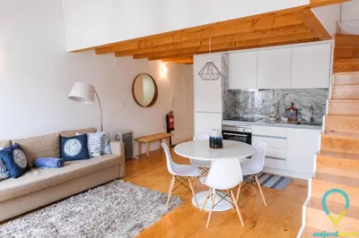 a living room with a couch and a table at Loft Almada in Porto
