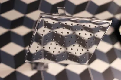 a glass vase on a black and white checkered floor at HM - Ribeira São João 1B in Porto