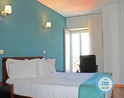 a bedroom with a bed with a blue wall at Vivacity Porto - Rooms & Apartments in Porto