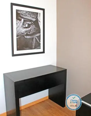 a black console table in a room with a picture on the wall at Vivacity Porto - Rooms & Apartments in Porto