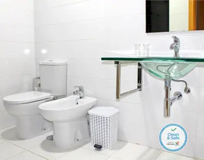 a bathroom with a toilet and a sink at Vivacity Porto - Rooms & Apartments in Porto