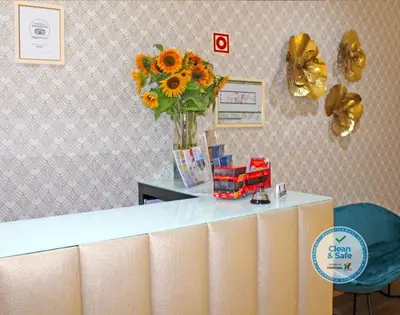 a vase of sunflowers on a counter in a room at Vivacity Porto - Rooms & Apartments in Porto