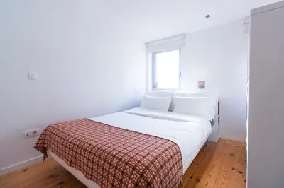 a white bed in a room with a window at ON Apartments - Violin in Porto