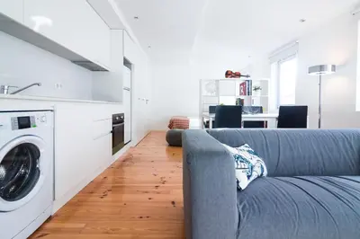 a living room with a couch and a washing machine at ON Apartments - Violin in Porto