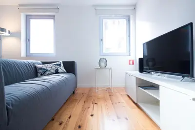 a living room with a couch and a flat screen tv at ON Apartments - Violin in Porto