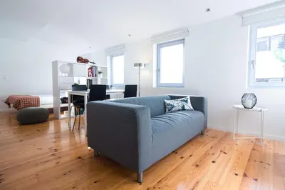 a living room with a blue couch and a table at ON Apartments - Violin in Porto