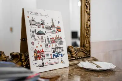a painting on a table with a plate and a mirror at Formosa Apartment with Free Parking and Historic Charm! in Porto