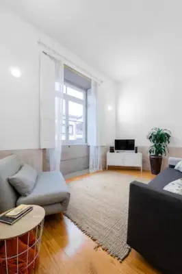 a living room with a couch and a table at Formosa Apartment with Free Parking and Historic Charm! in Porto