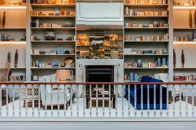 a room with shelves with chairs and a fireplace at Torel 1884 Suites & Apartments in Porto