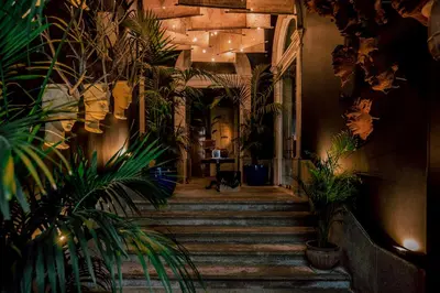 a hallway with stairs and plants in a building at Torel 1884 Suites & Apartments in Porto