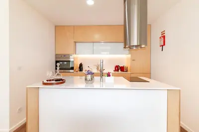 a kitchen with a white counter top in a room at Ceuta Inn Porto in Porto