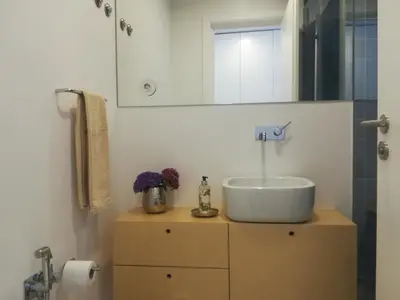 a bathroom with a sink and a mirror at Ceuta Inn Porto in Porto