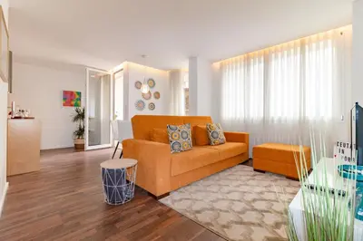 a living room with a couch and a table at Ceuta Inn Porto in Porto