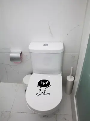 a bathroom with a toilet with a sticker on it at Central Cozy Star 1 Balcony AC Near Merto in Porto