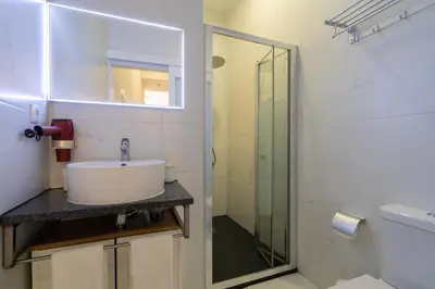 a bathroom with a sink and a glass shower at Central Cozy Star 1 Balcony AC Near Merto in Porto
