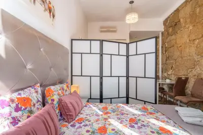 a bedroom with a bed and a brick wall at Central Cozy Star 1 Balcony AC Near Merto in Porto