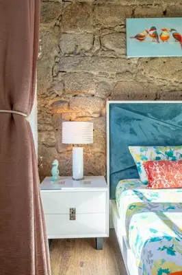 a bedroom with a bed with a blue headboard and two lamps at Central Cozy Stay 2 AC Near Metro in Porto