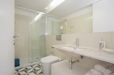 a bathroom with a sink and a toilet and a shower at Liiiving in Porto | Historic & Sunny Terrace in Porto