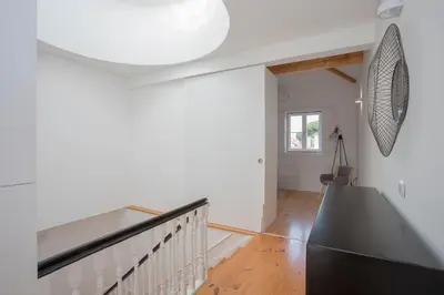 a white hallway with a staircase in a house at Liiiving in Porto | Historic & Sunny Terrace in Porto