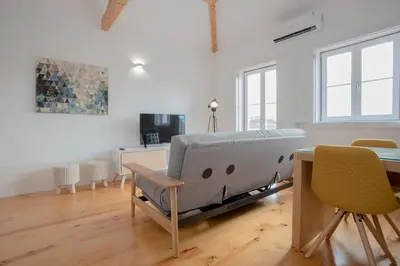 a living room with a couch and a table at Liiiving in Porto | Historic & Sunny Terrace in Porto