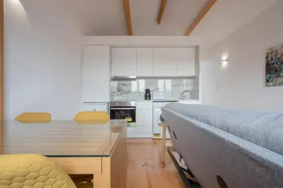 a kitchen with a table and a bed in a room at Liiiving in Porto | Historic & Sunny Terrace in Porto