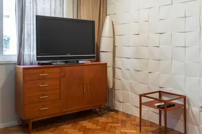 a television on a wooden dresser in a room at Go2oporto @Ceuta in Porto