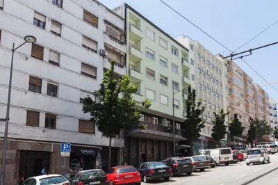 a busy city street with cars parked in front of buildings at Go2oporto @Ceuta in Porto