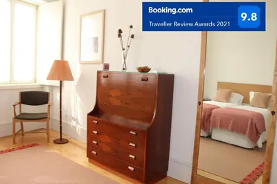 a bedroom with a dresser and a bed and a mirror at Amazing City Center Apartment Porto Villa Lóios in Porto
