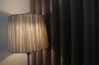 a lamp in a room next to a curtain at Amazing City Center Apartment Porto Villa Lóios in Porto