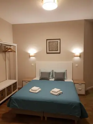 a bedroom with a bed with two towels on it at HaoBo Porto Center in Porto