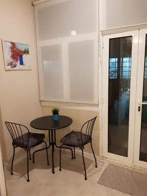 a table and chairs in a room with a window at HaoBo Porto Center in Porto