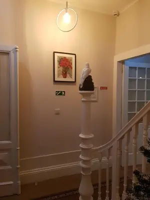 a hallway with a staircase with a statue on a column at HaoBo Porto Center in Porto