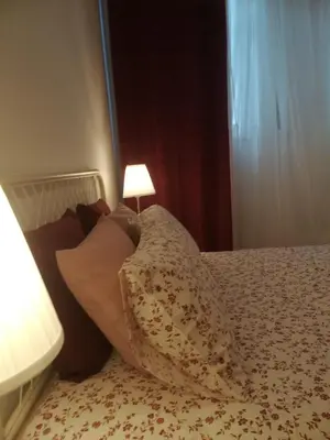 a bed with a pillow and a lamp on it at Oportobestview in Porto