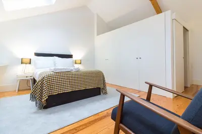 a bedroom with a bed and a chair at ON Apartments - Palace - Free Parking in Porto