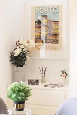 a living room with a table with flowers and a picture at HM - OPorto City View in Porto