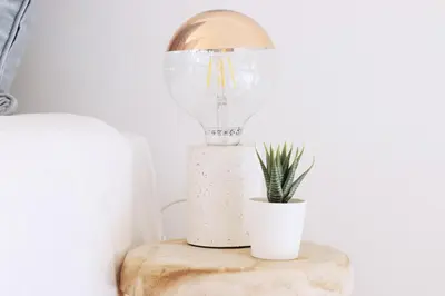 a light bulb on a table with a potted plant at HM - OPorto City View in Porto