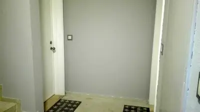 a hallway with a white wall and a door at Downtown Porto Spot in Porto